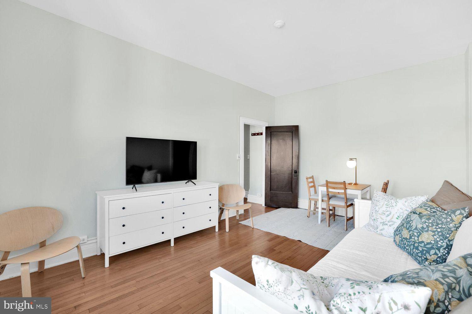 1725 17th Street Northwest, Unit 503 Washington, DC 20009 - Photo 6 of 24 a living room with furniture and a flat screen tv