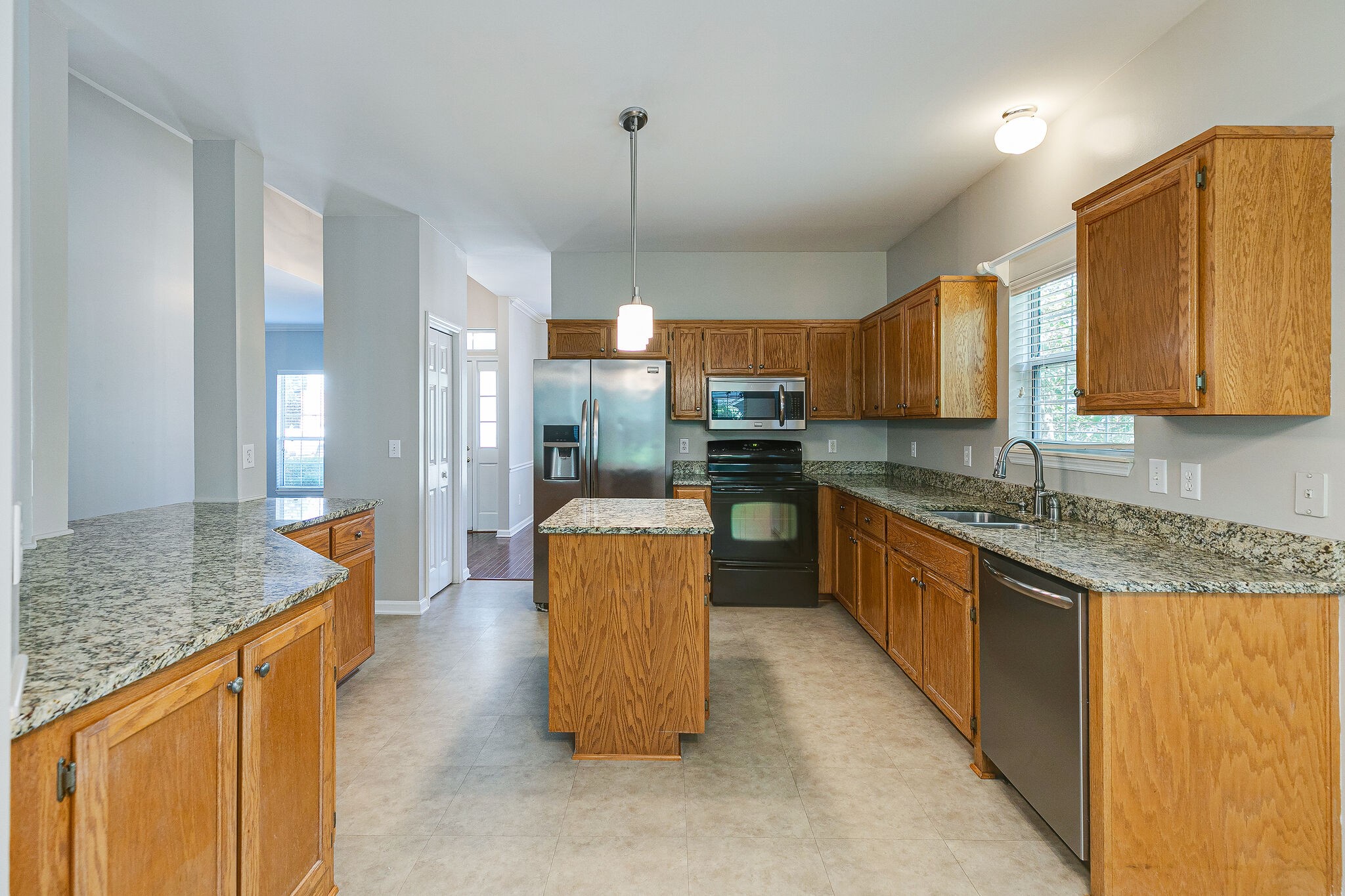 320 Cannonade Circle Franklin, TN 37069 - Photo 13 of 30 a kitchen with stainless steel appliances granite countertop a sink stove and refrigerator