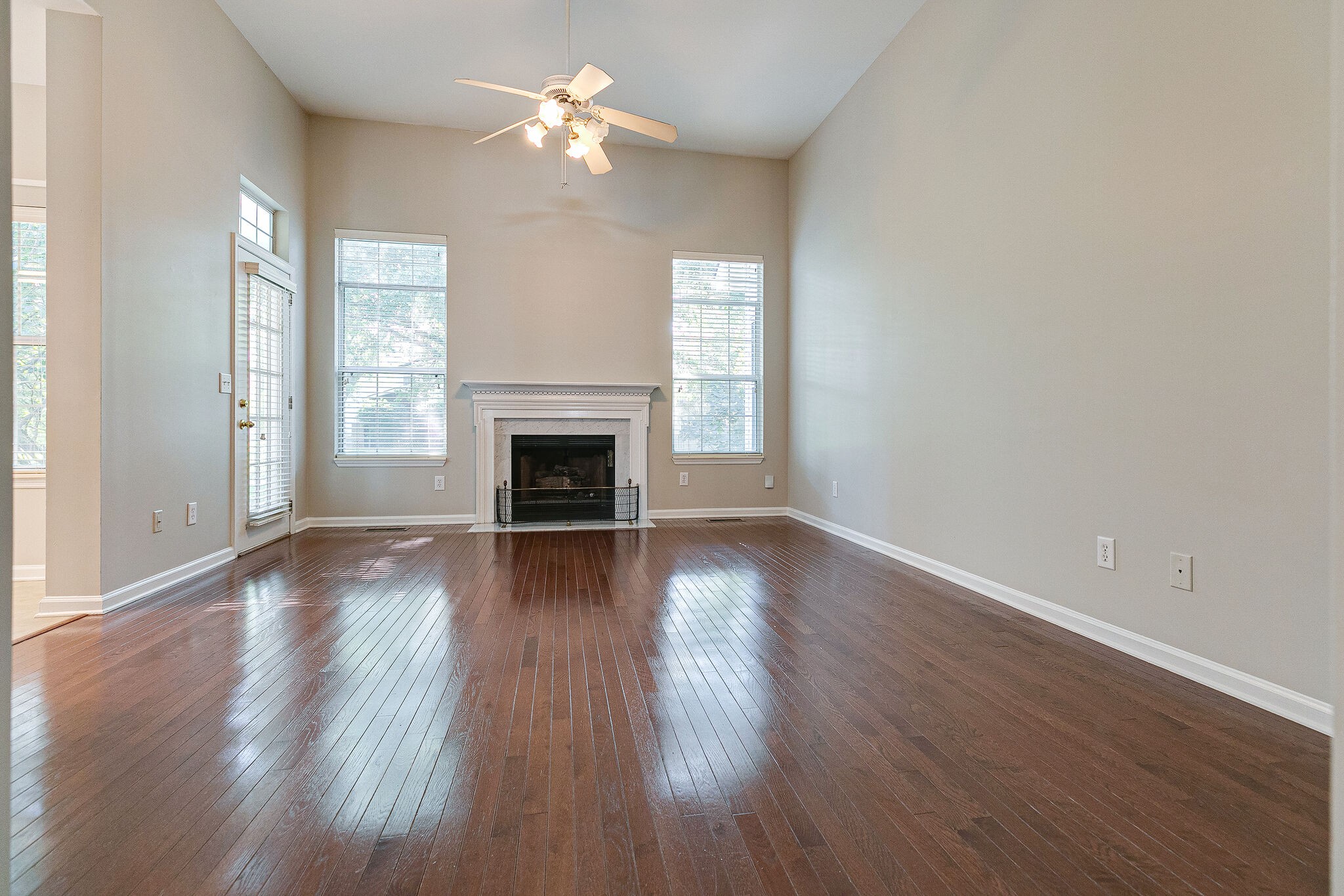 320 Cannonade Circle Franklin, TN 37069 - Photo 9 of 30 an empty room with wooden floor fireplace and windows