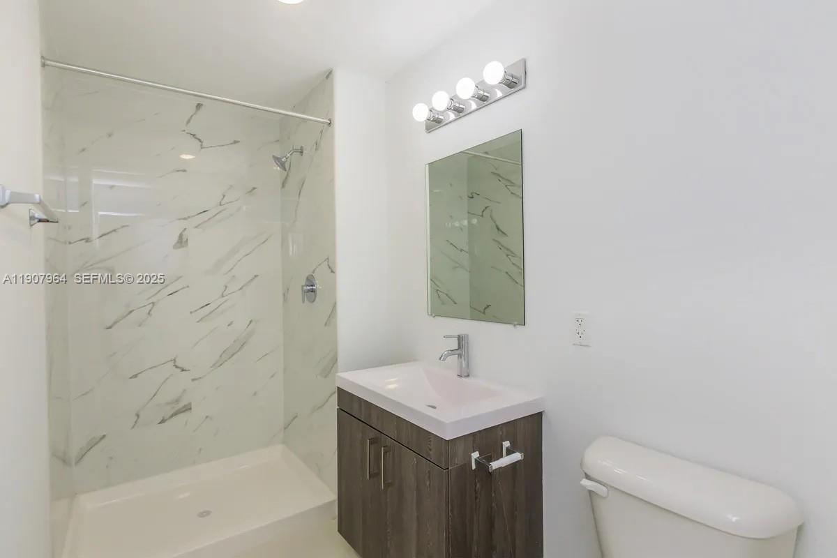 25850 Southwest 140th Court, Unit 6111 Homestead, FL 33032 - Photo 11 of 25 a bathroom with a sink a toilet and shower
