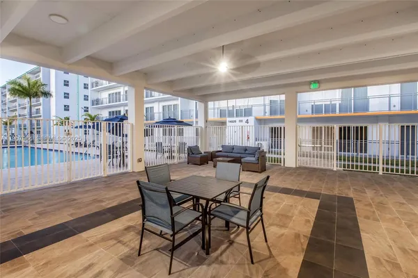 a view of a dining room with furniture and a floor to ceiling window