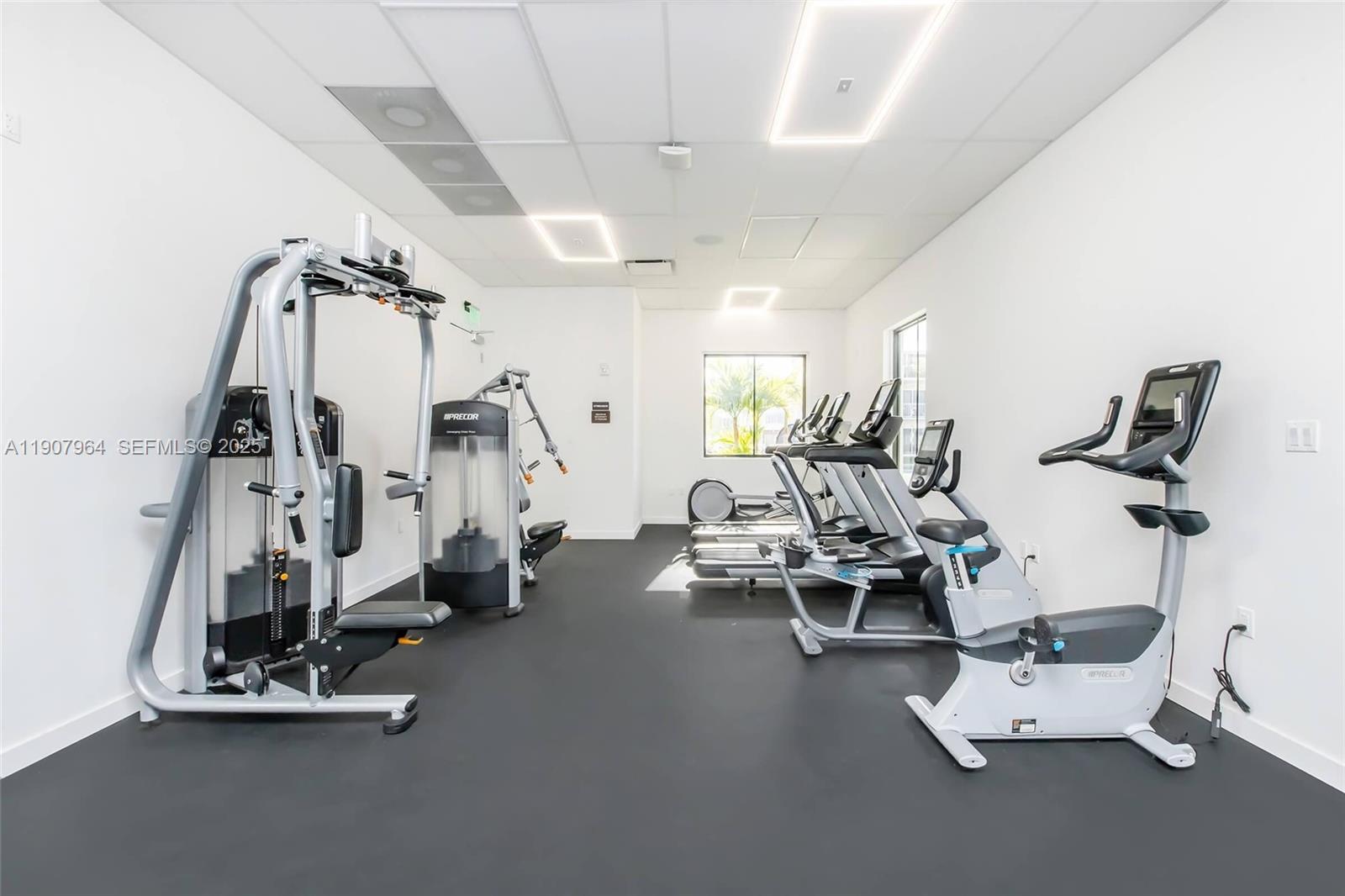 25850 Southwest 140th Court, Unit 6111 Homestead, FL 33032 - Photo 19 of 25 a view of a room with gym equipment