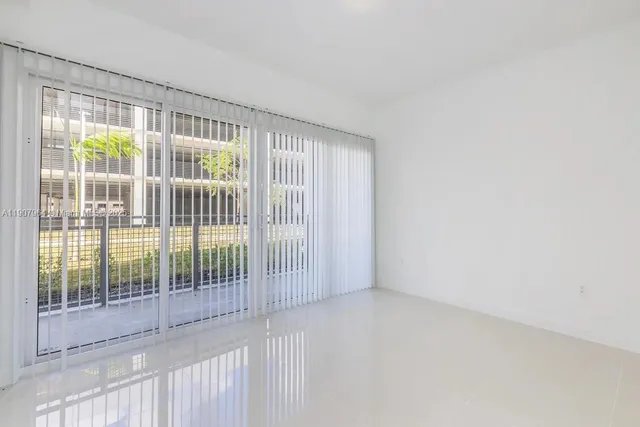 a view of empty room with floor to ceiling window