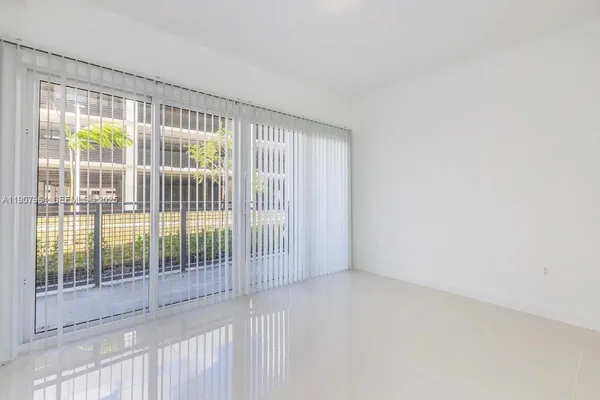 a view of empty room with floor to ceiling window