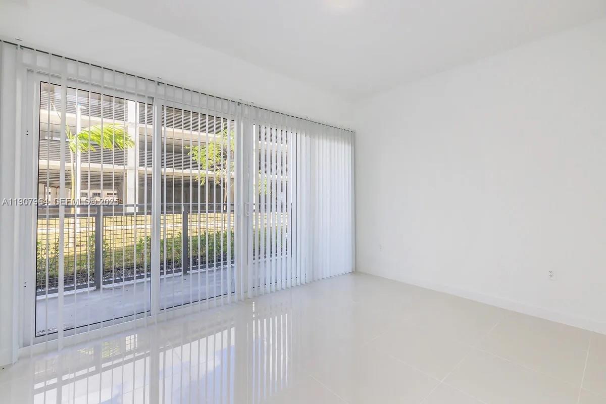 25850 Southwest 140th Court, Unit 6111 Homestead, FL 33032 - Photo 4 of 25 a view of empty room with floor to ceiling window