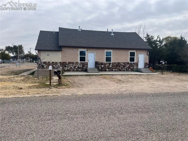 a front view of a house with yard and seating area