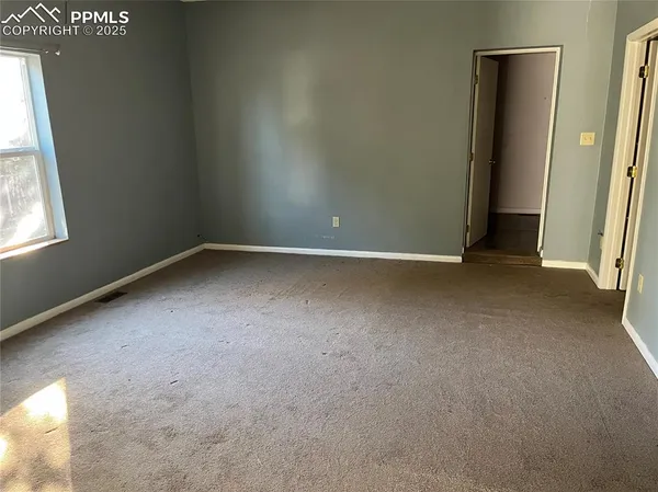 a view of hallway with closet and a fireplace