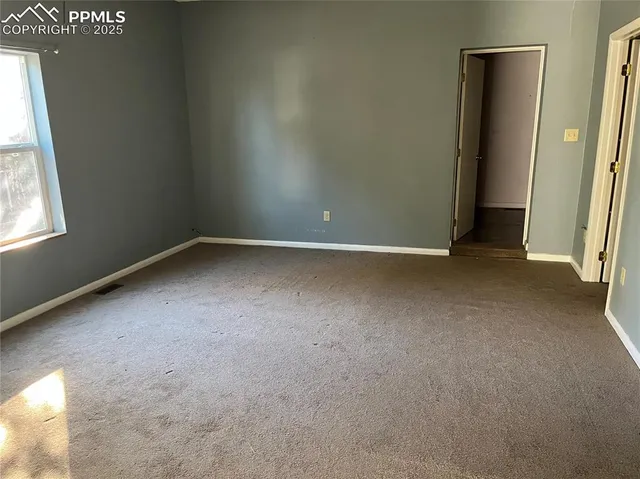 a view of hallway with closet and a fireplace