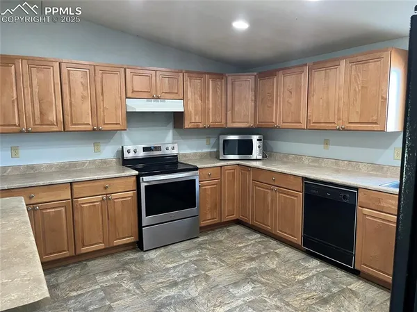 a kitchen with a refrigerator and a sink