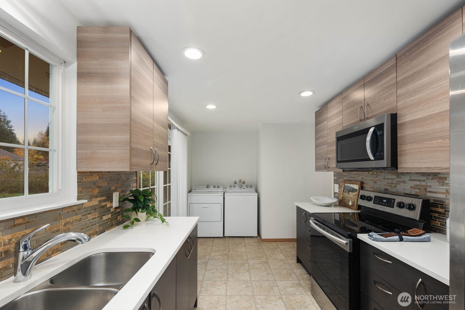 803 Southwest Dash Point Road Federal Way, WA 98023 - Photo 11 of 35 a kitchen with stainless steel appliances a sink stove and cabinets