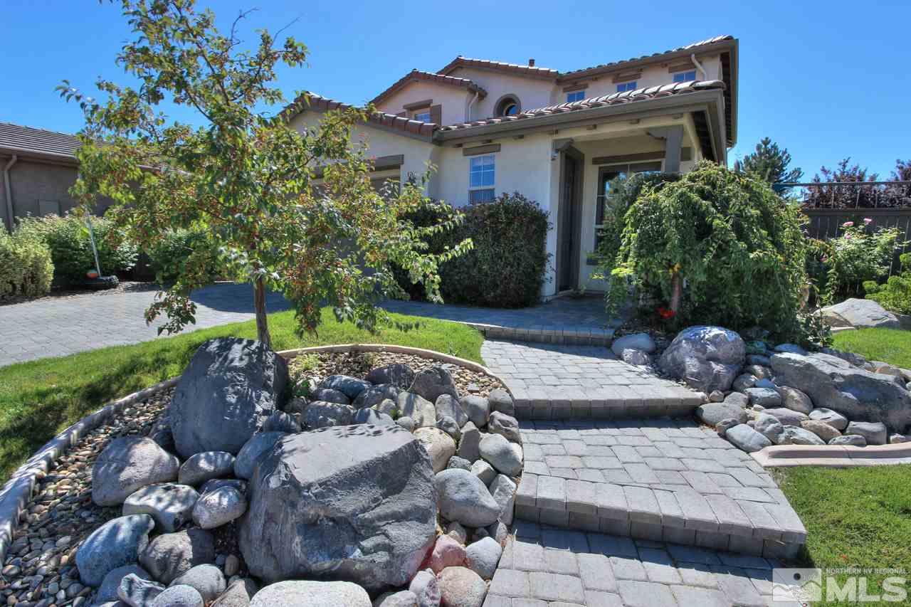 a view of a house with a yard and plants