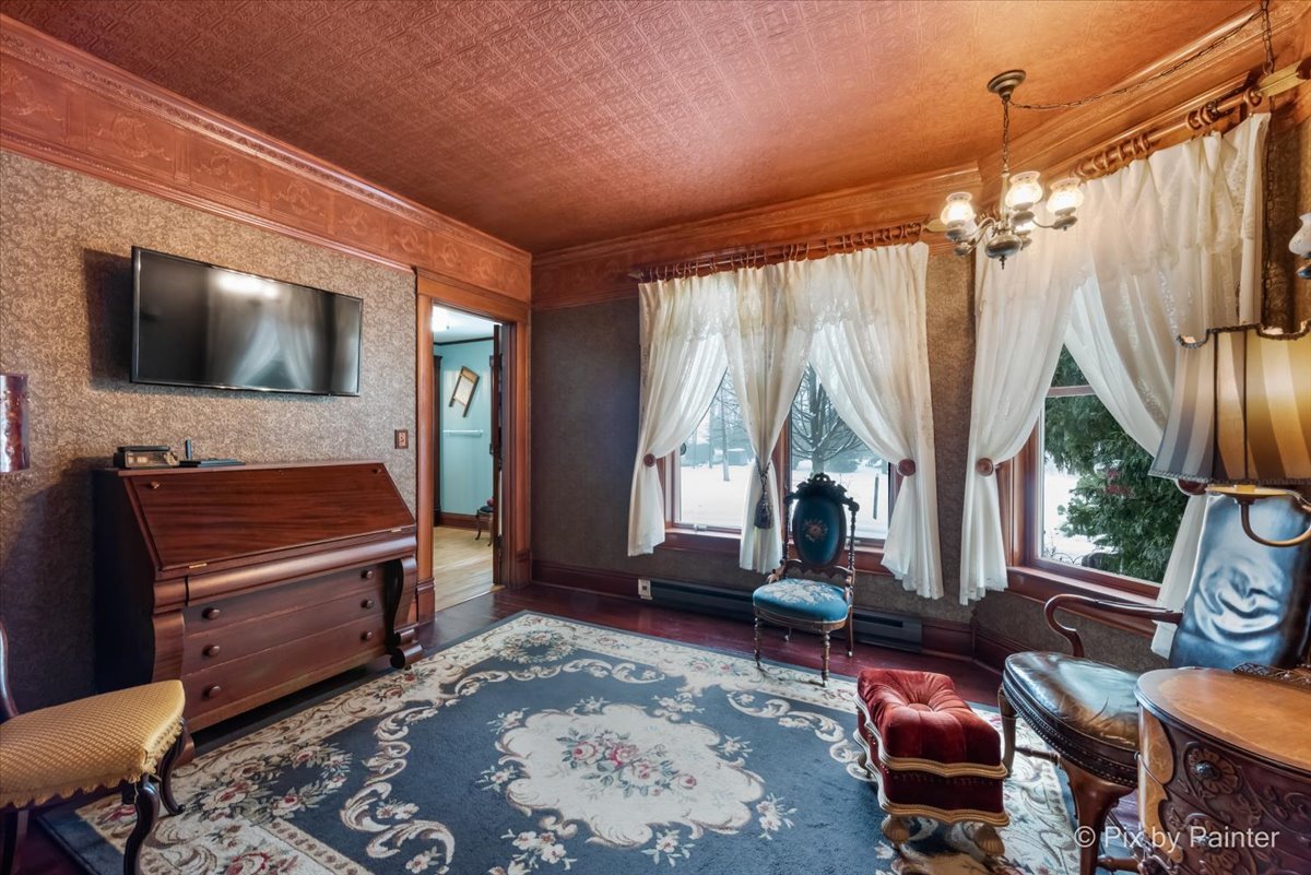 11004 Vanderkarr Road Hebron, IL 60034 - Photo 15 of 35 a living room with furniture a flat screen tv and a large window