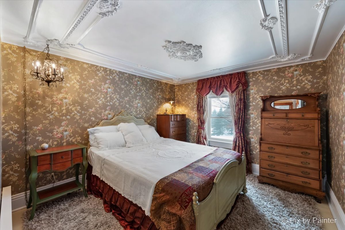 11004 Vanderkarr Road Hebron, IL 60034 - Photo 20 of 35 a bedroom with a bed and a mirror