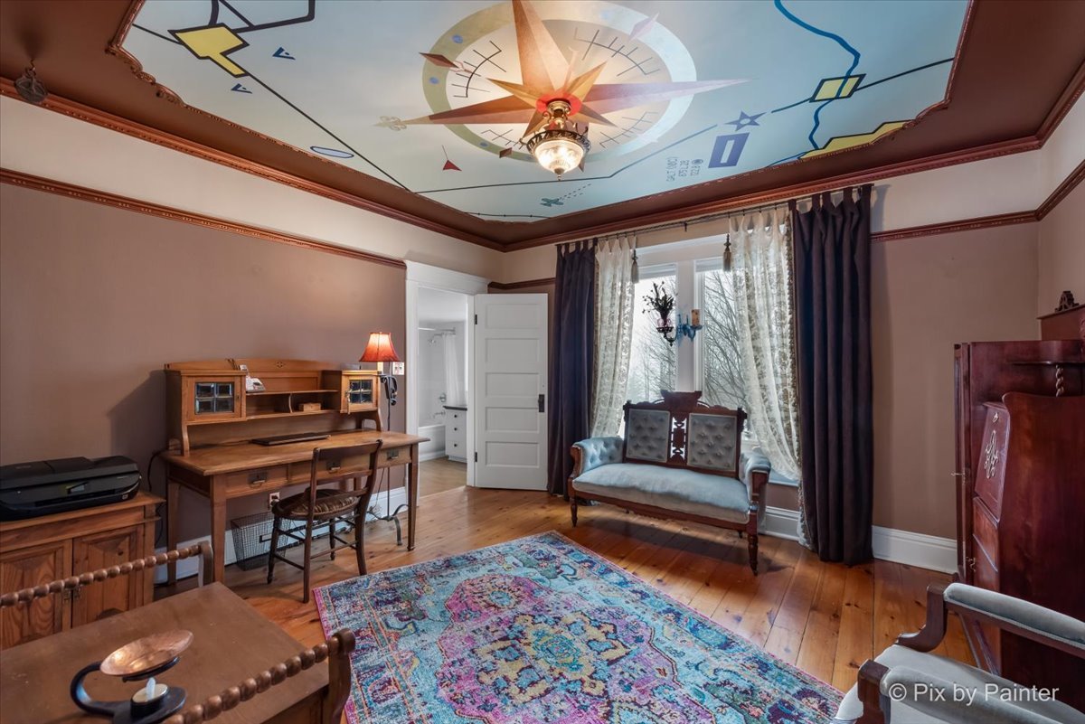 11004 Vanderkarr Road Hebron, IL 60034 - Photo 21 of 35 a living room with furniture a piano and a bookshelf