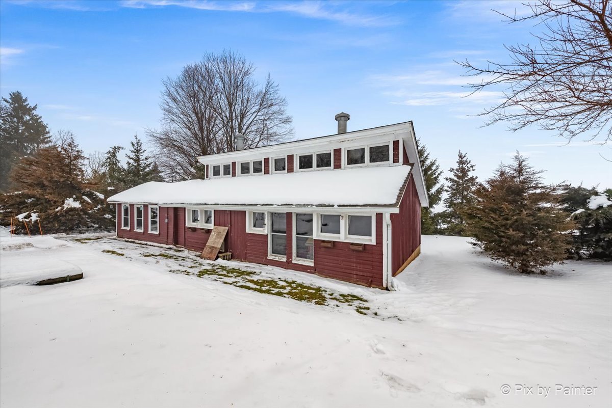 11004 Vanderkarr Road Hebron, IL 60034 - Photo 30 of 35 a front view of a house with a yard covered in snow