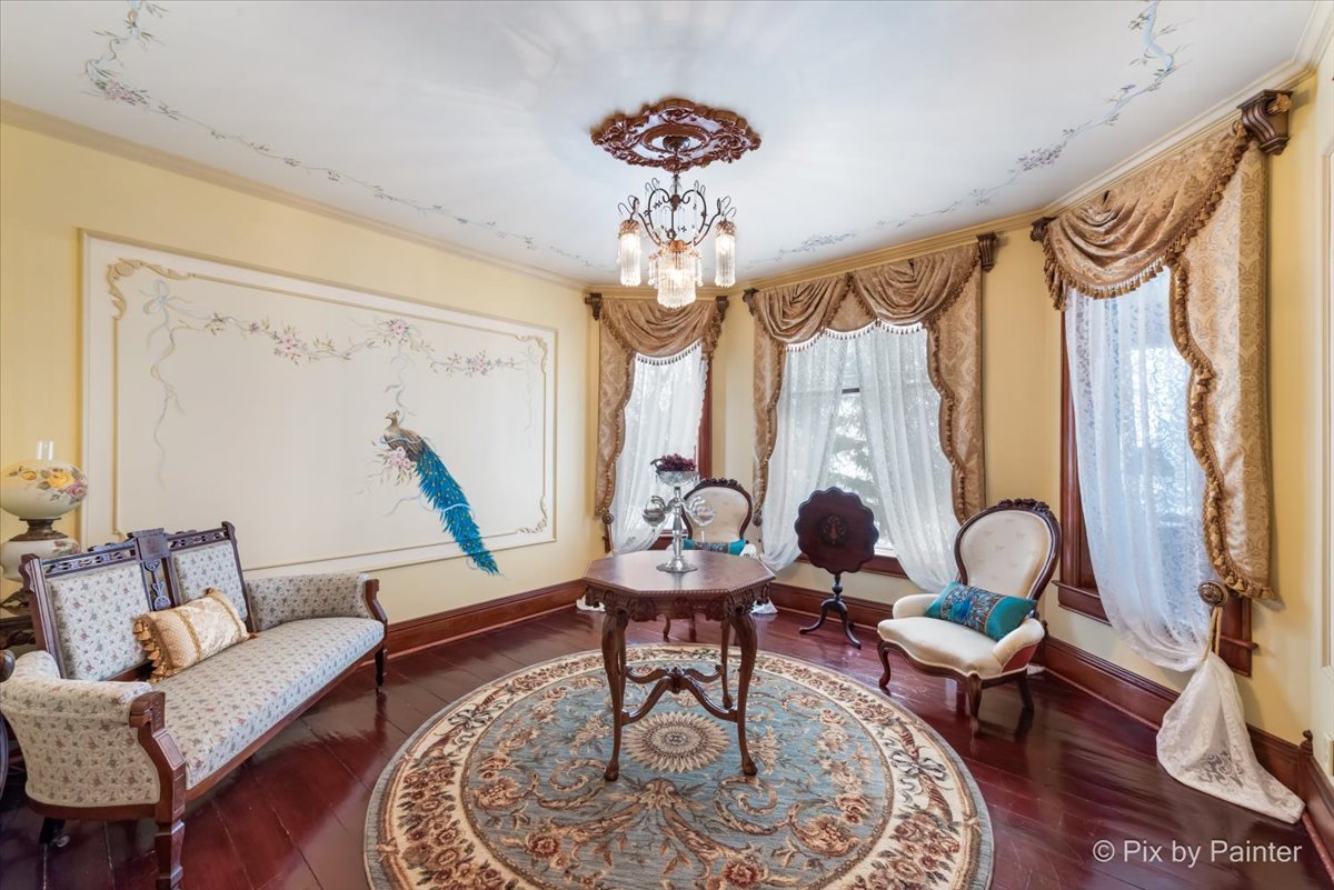 11004 Vanderkarr Road Hebron, IL 60034 - Photo 9 of 35 a living room with furniture a chandelier and a window