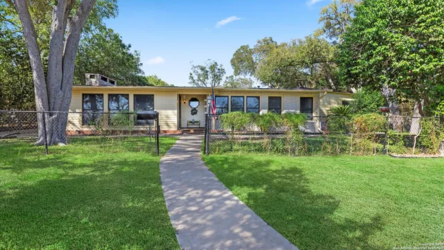 a front view of house with yard and green space