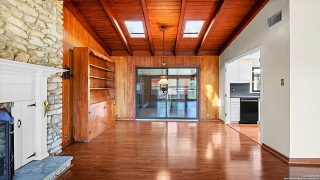 a kitchen with granite countertop a refrigerator and a sink