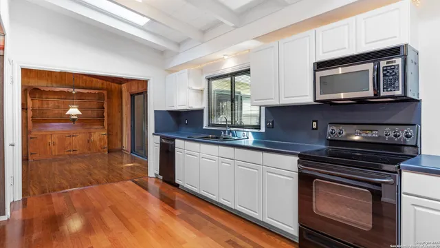 a view of an empty room with glass door and balcony