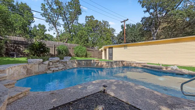 a view of a swimming pool with a patio