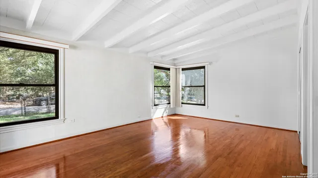 a spacious bedroom with a bed and a large window