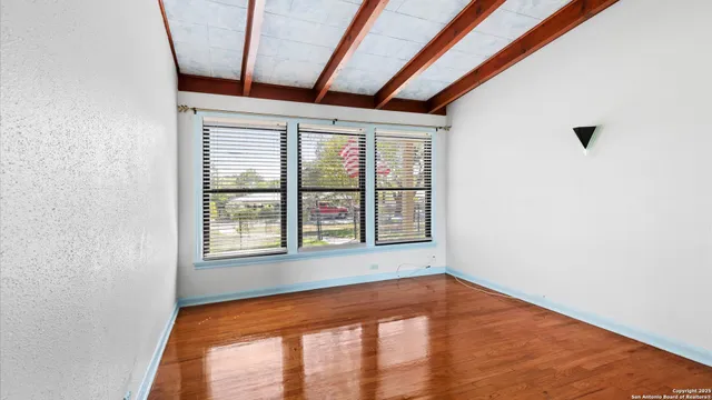 a bedroom with a large bed and a window