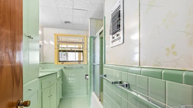 a bathroom with a glass shower door