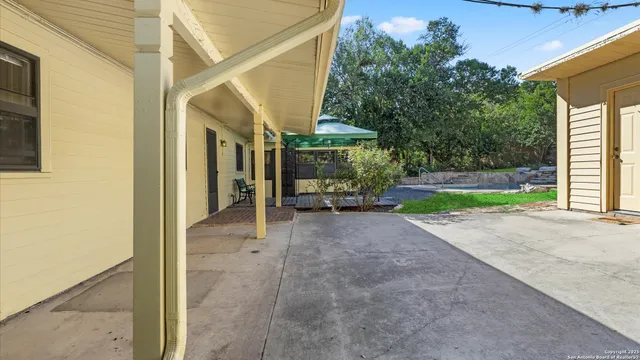 a view of a backyard with wooden fence