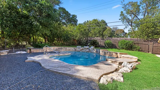 a view of a hallway with bathroom and mirror