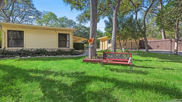 a view of a chair and table in backyard of the house