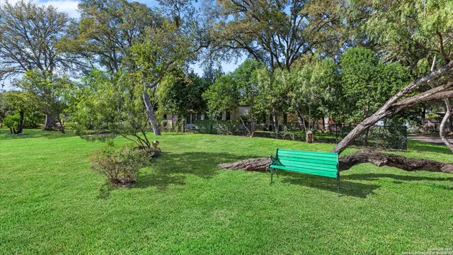 a view of a house with backyard and sitting area