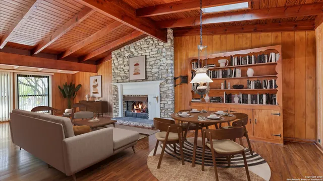 a living room with furniture a fireplace and a table