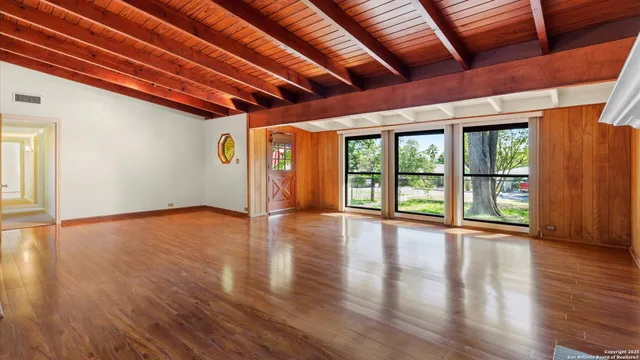 a living room with a fireplace and a wooden floor