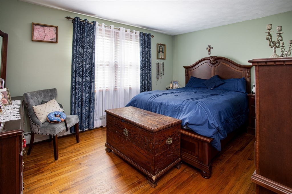 166 Stonehaven Road Fall River, MA 02723 - Photo 13 of 33 a bedroom with a bed and wooden floor