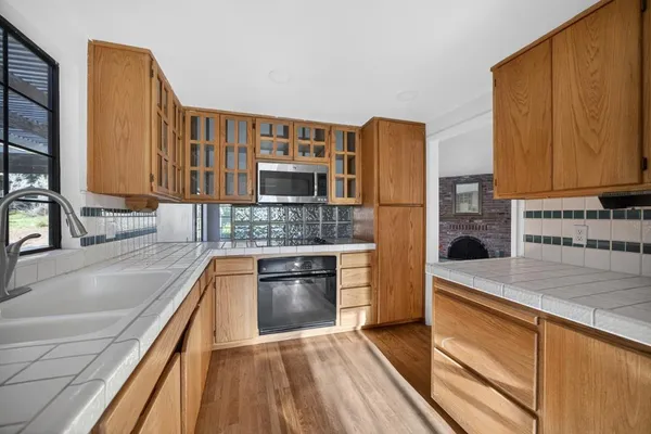 a kitchen with stainless steel appliances granite countertop a sink and a stove