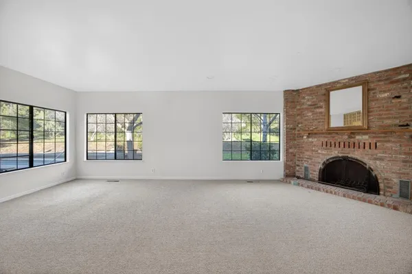 a view of empty room with a fireplace