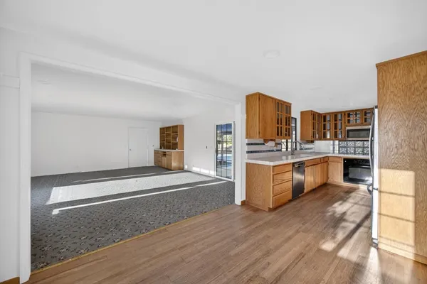 a spacious bedroom with a bed and cabinets