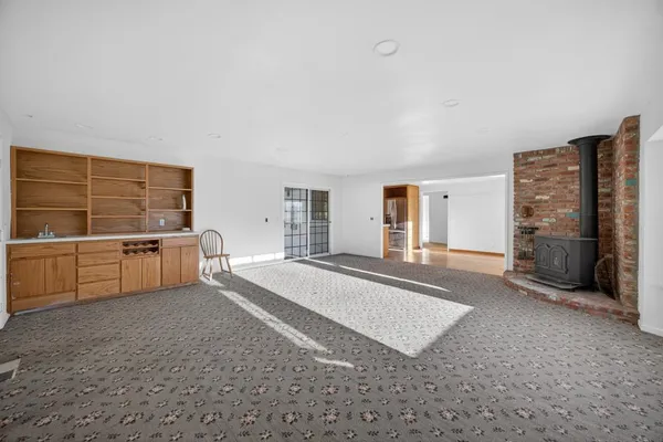 a view of a bedroom with furniture and window