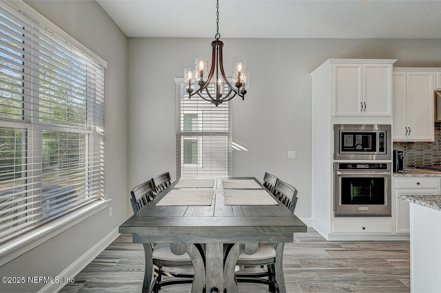 264 Vly Fls Way St. Johns, FL 32259 - Photo 16 of 37 a kitchen with stainless steel appliances granite countertop a stove a kitchen island a stove a table and chairs