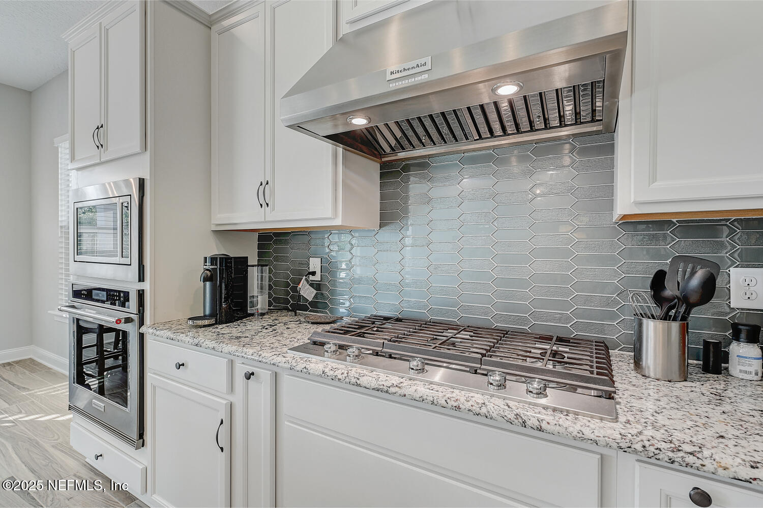 264 Vly Fls Way St. Johns, FL 32259 - Photo 18 of 37 a kitchen with granite countertop a sink stainless steel appliances and white cabinets