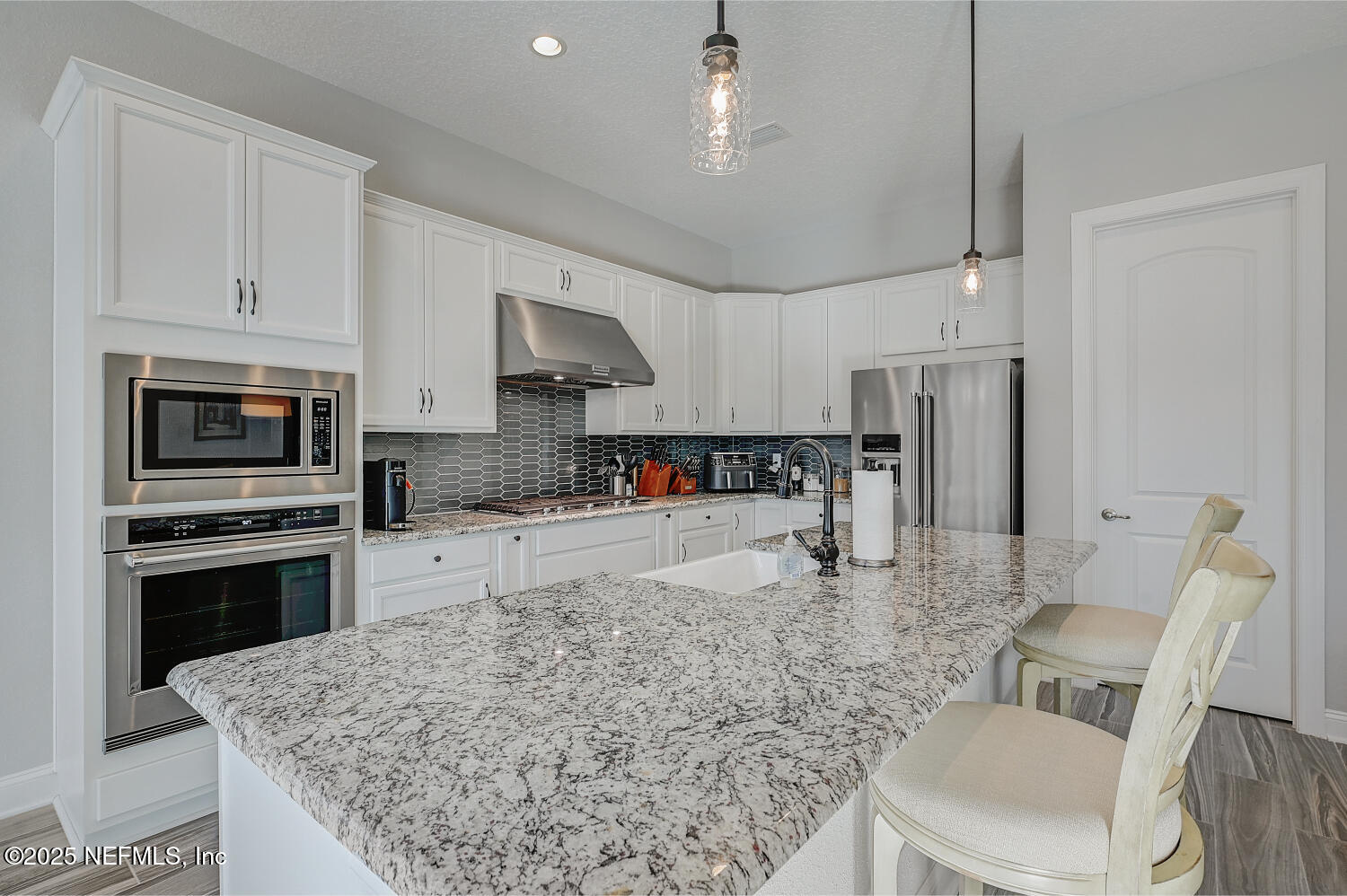 264 Vly Fls Way St. Johns, FL 32259 - Photo 4 of 37 a kitchen with stainless steel appliances granite countertop a stove top oven a sink a refrigerator a dining table and chairs