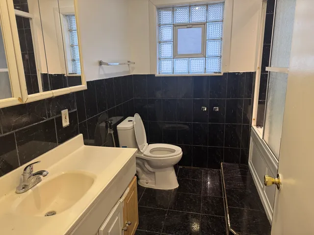 a bathroom with a sink a toilet and a mirror