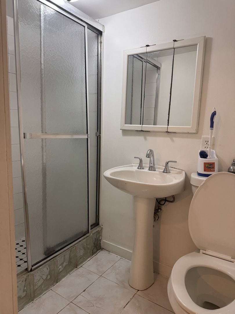 1634 West Morse Avenue, Unit C Chicago, IL 60626 - Photo 22 of 27 a bathroom with a sink toilet and shower