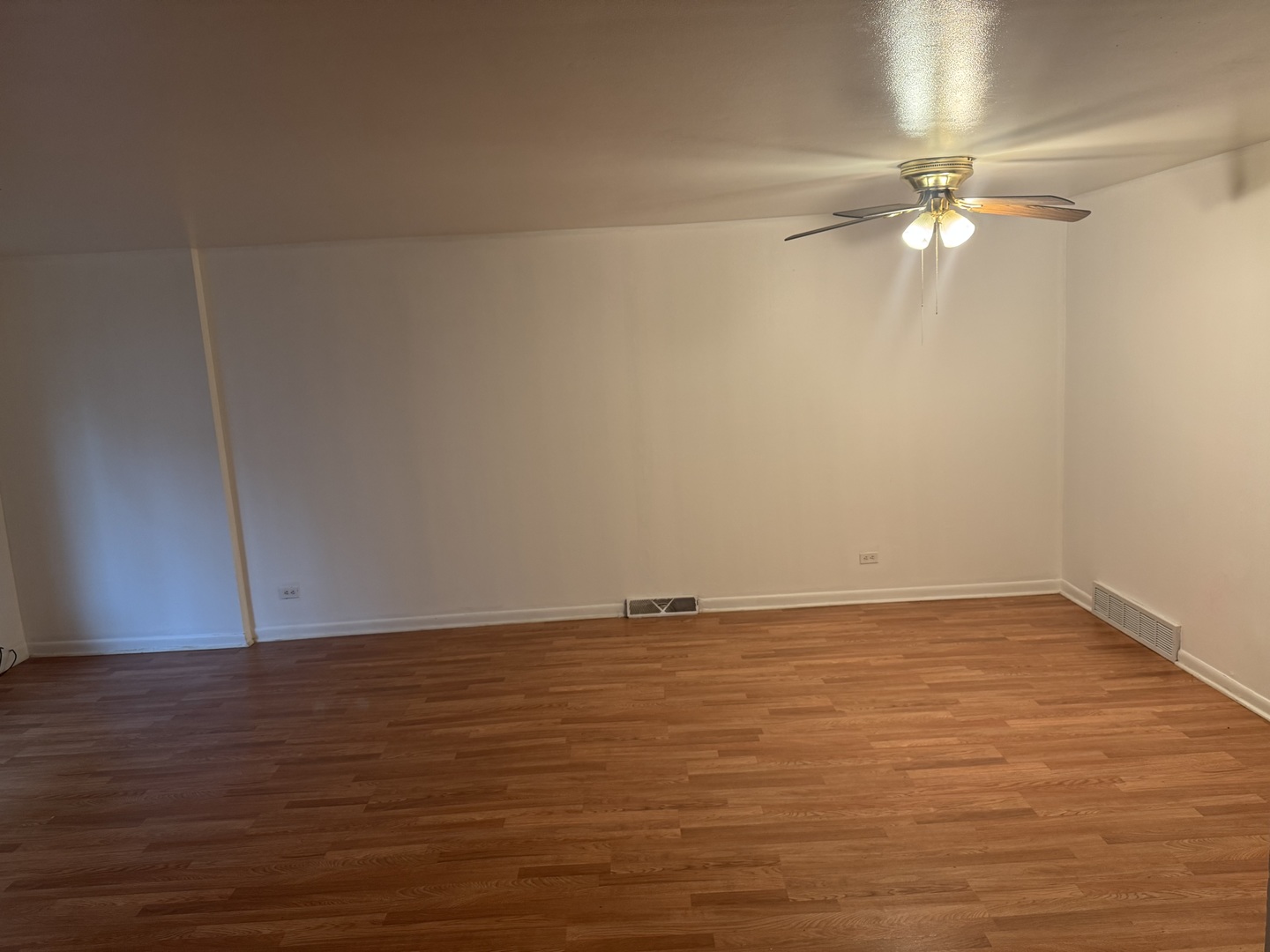 1634 West Morse Avenue, Unit C Chicago, IL 60626 - Photo 9 of 27 a view of an empty room with wooden floor