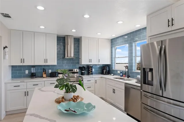 a spacious bedroom with a bed a flat screen tv and a large window