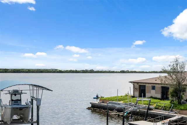 a view of a hallway with wooden floor and a living room