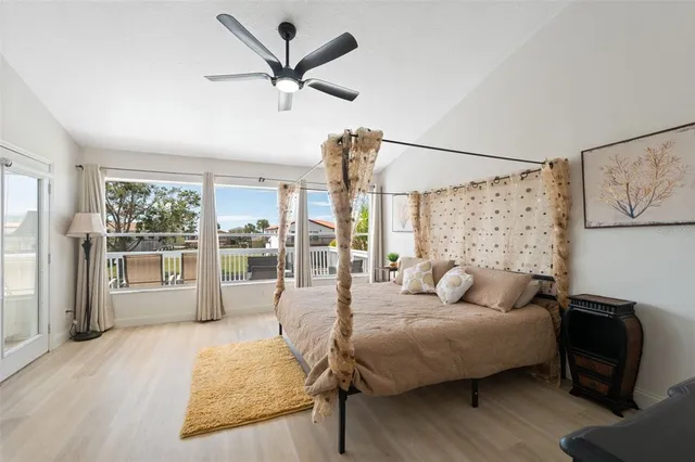 a bedroom with a bed and a flat tv screen on dresser