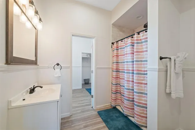 a front view of a house with a yard and palm trees