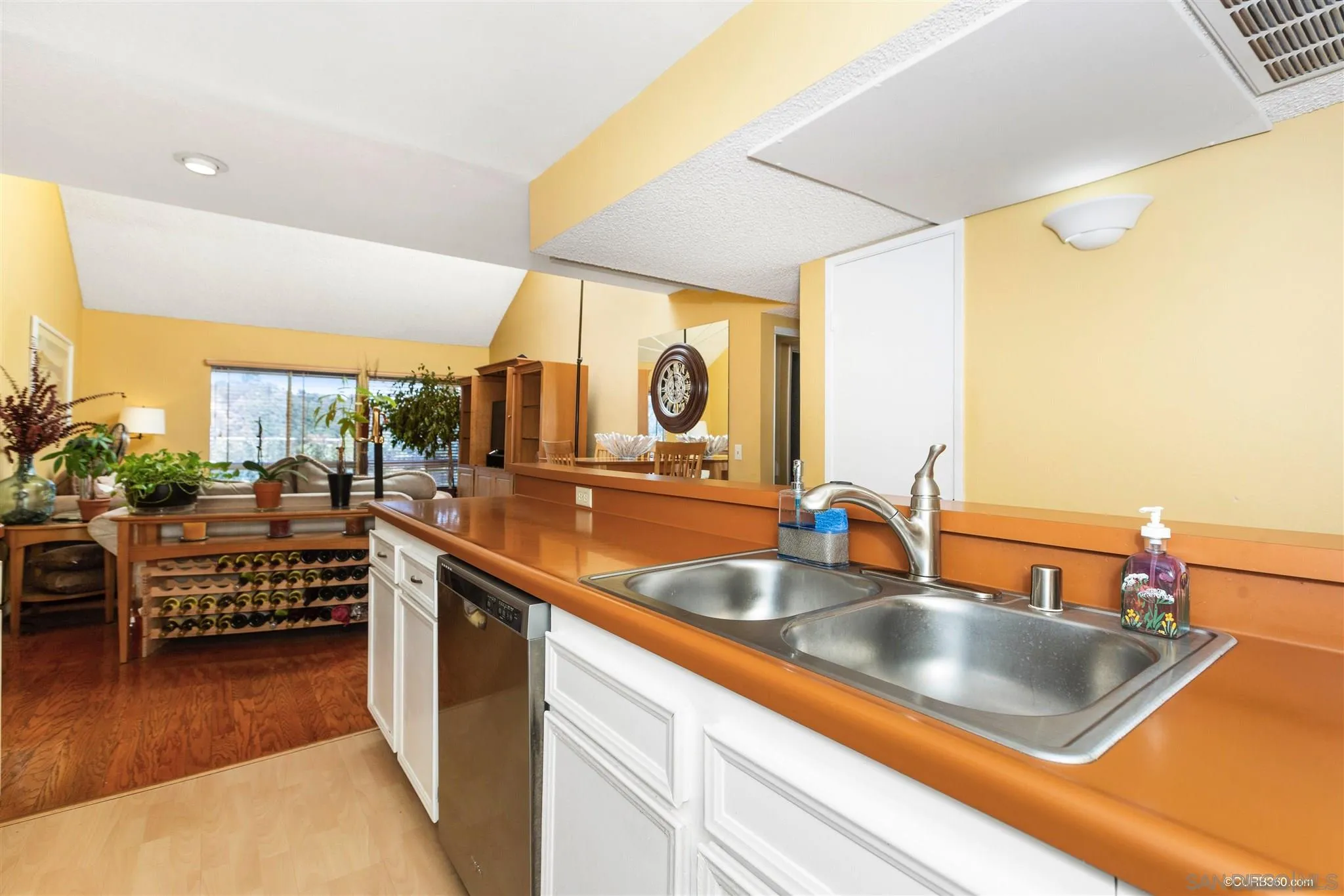 6191 Rancho Mission Road, Unit 311 San Diego, CA 92108 - Photo 4 of 27 a kitchen with stainless steel appliances a sink and a large window