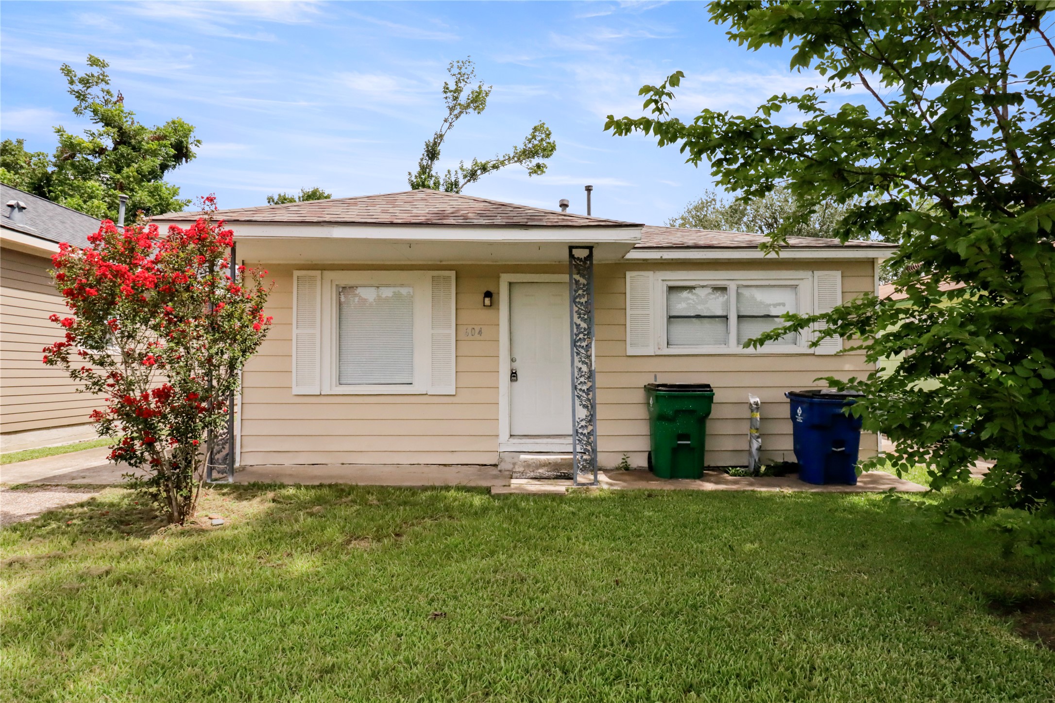 604 West Peach Street Angleton, TX 77515 - Photo 1 of 15 a front view of a house with a garden